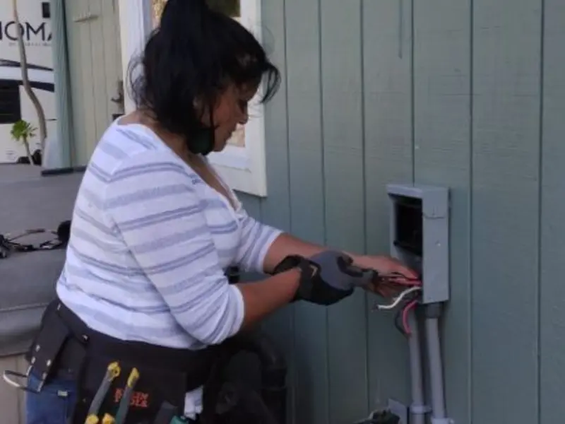 Licensed electrician wiring an exterior subpanel in Las Cruces